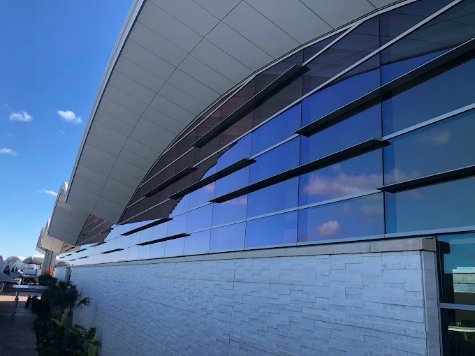 Curved glass terminal facade with blue solar control window film