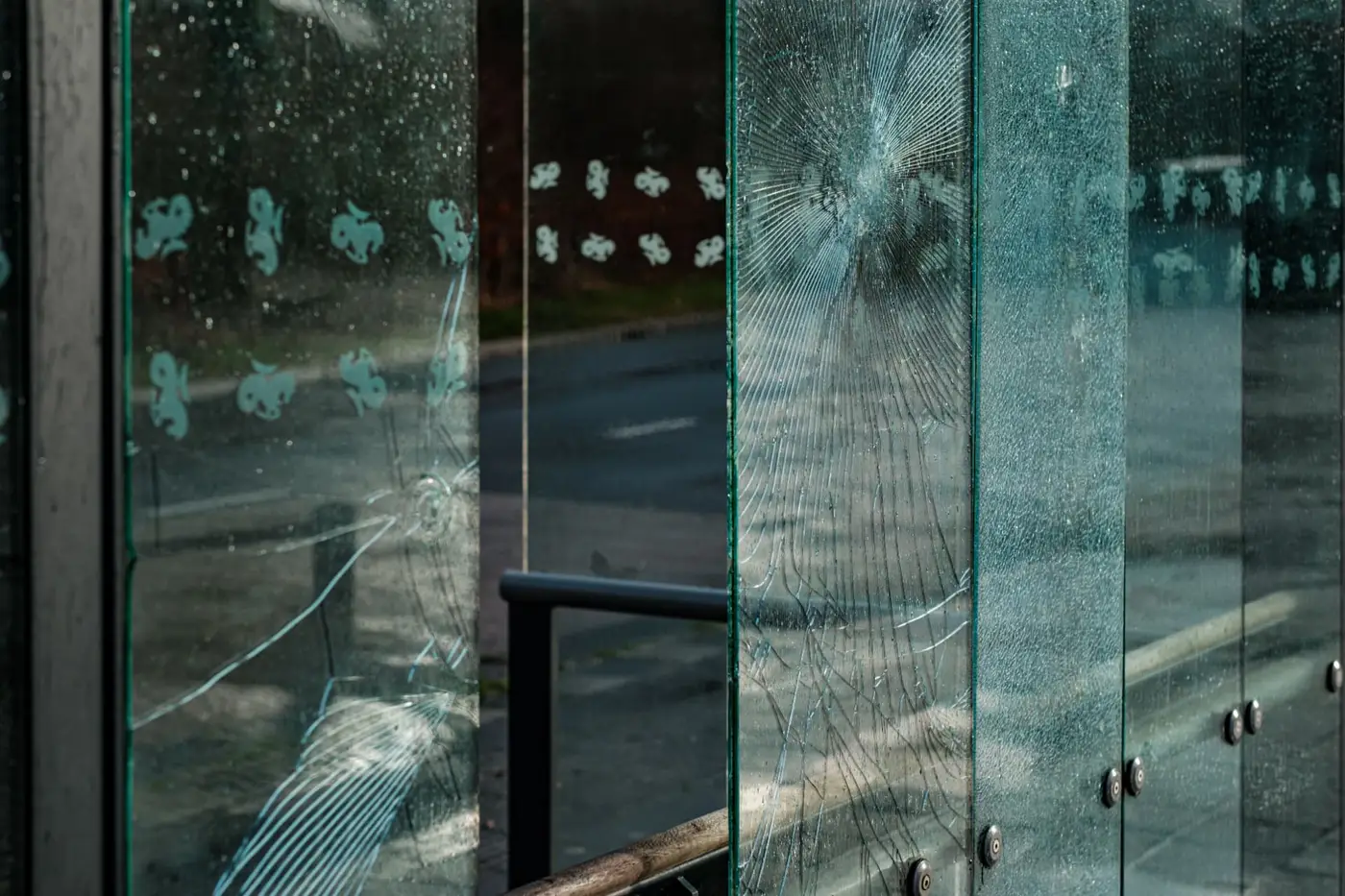 Impacted glass panels held intact by 3M Scotchshield security window film