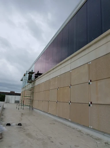 Commercial building exterior glazing panels during security film retrofit