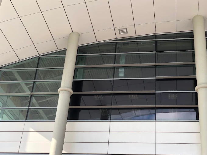 Commercial building column bay glass elevation with window film
