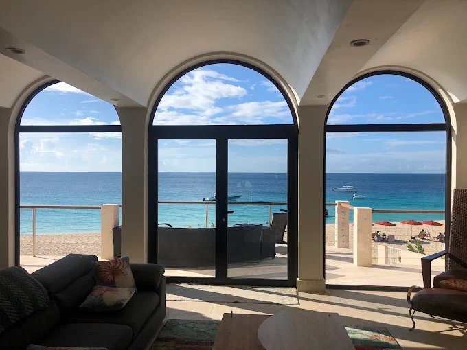 Living room with arched windows and ocean view protected by window film