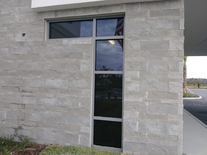 Stone facade building storefront glass with window film