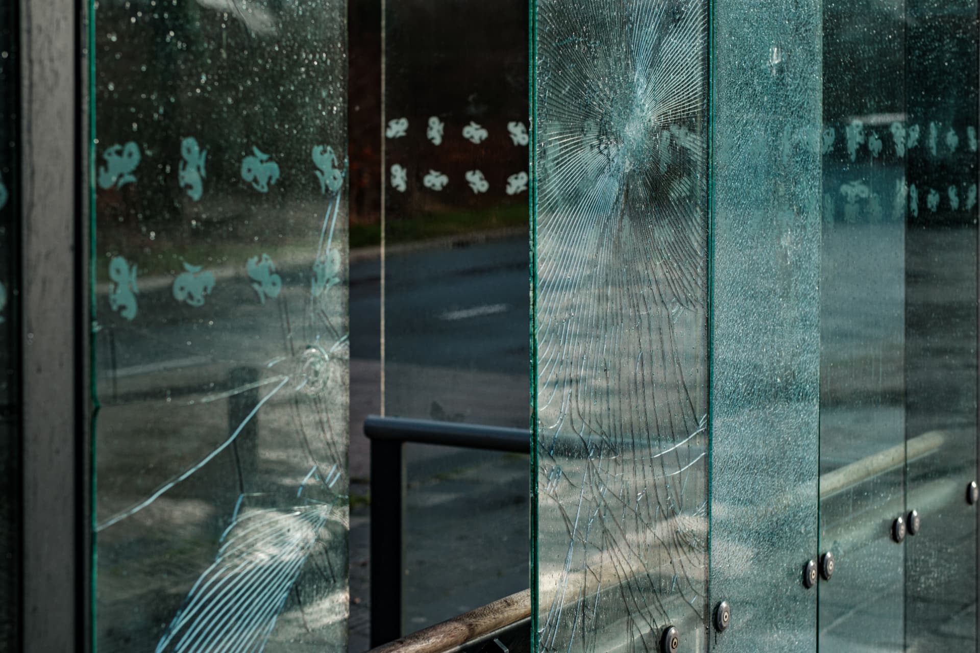 Impacted glass panels held intact by 3M Scotchshield security window film
